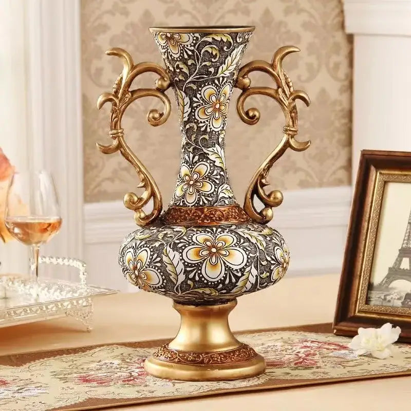Ornate black and gold resin vase dried flowers with floral pattern and golden handles for living room decor
