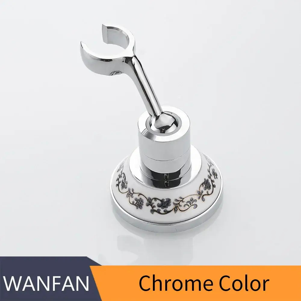 Chrome-finished bathroom towel rack with ornate floral pattern on circular base for handheld shower mount bracket use