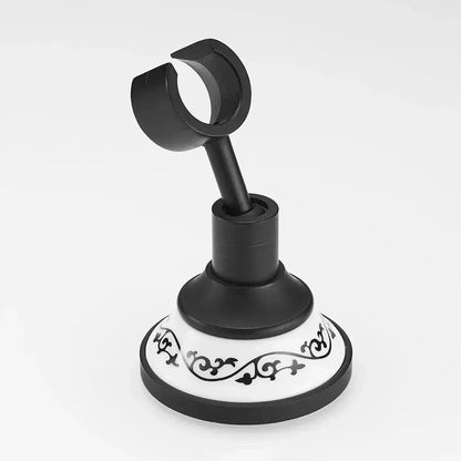 Ornate black and white ceramic wall-mounted shower mount bracket with scrollwork design for handheld shower use