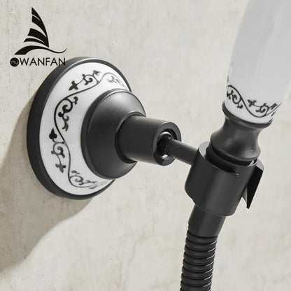 Ornate black and white ceramic wall-mounted shower mount bracket with scrollwork design for handheld shower use