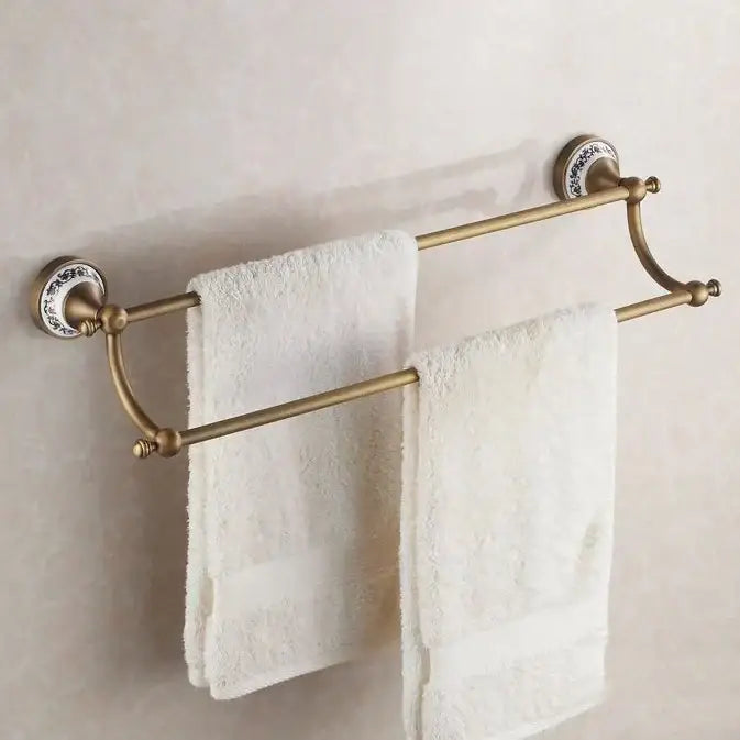 Antique brass double towel rack with ornate white ceramic end caps in bath hardware set for bathroom accessories