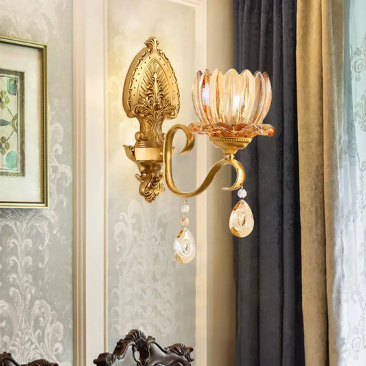 Ornate brass lotus wall sconce with gold-toned finish amber glass shade and dangling crystals for e14 bulb use