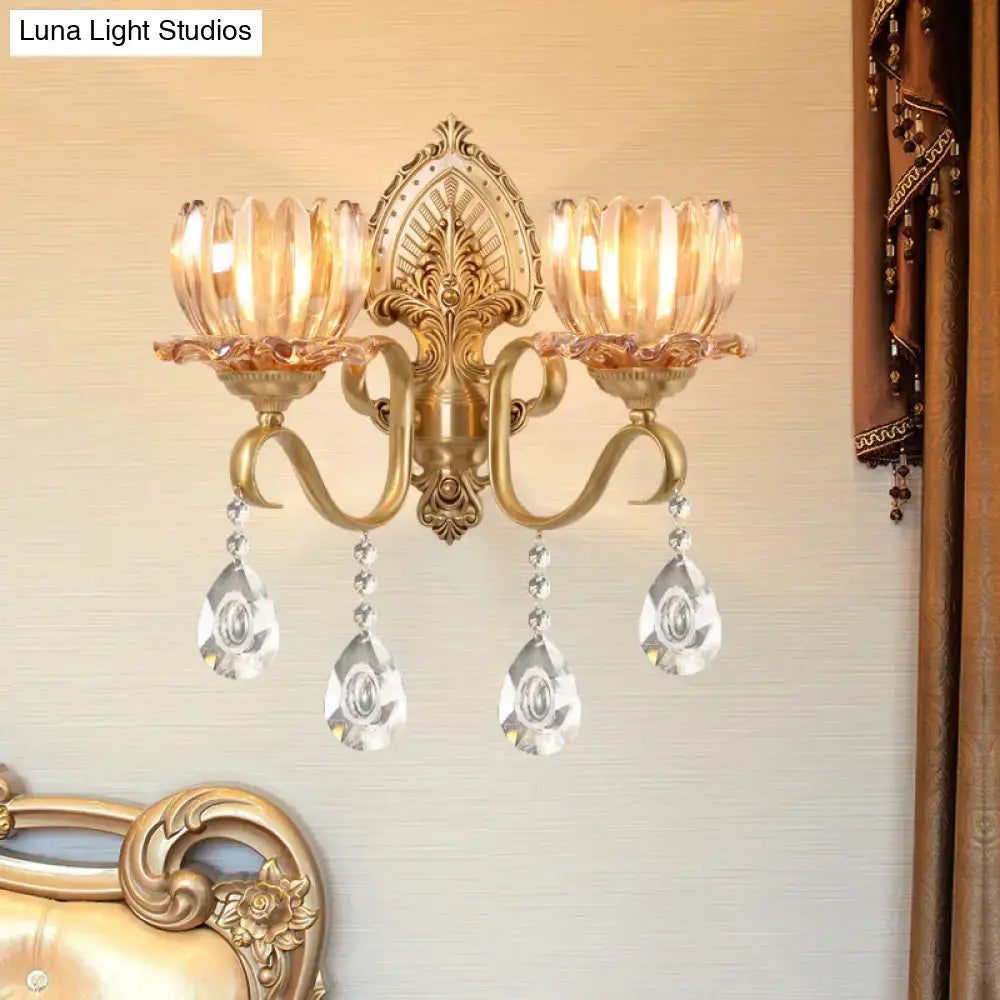 Ornate brass lotus wall sconce with gold-toned finish, amber glass, fluted crystal shades, and e14 bulb compatibility