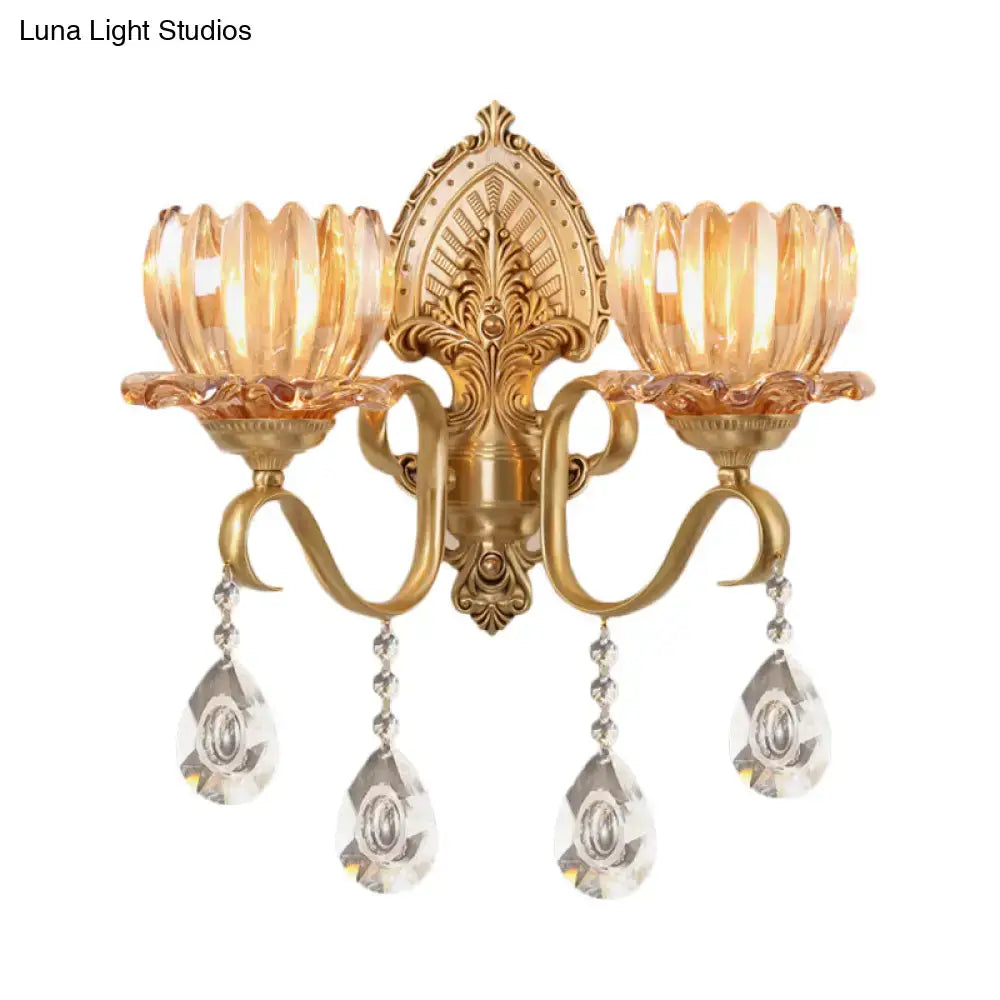 Ornate brass lotus wall sconce with gold-toned finish amber glass shades and dangling crystal pendants for e14 bulb use