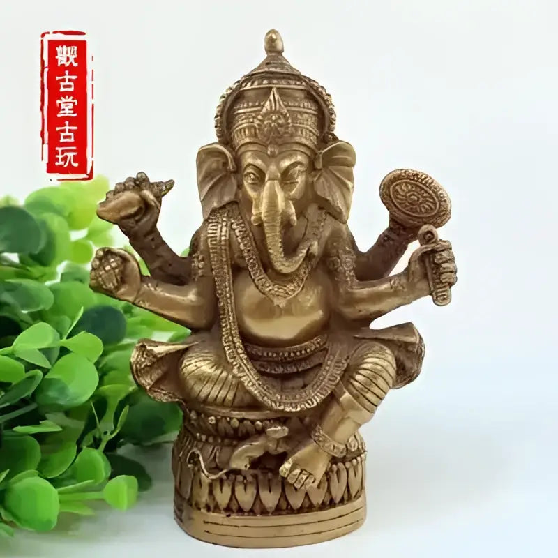 Ornate golden brass ganapati elephant buddha statue with multiple arms and traditional adornments for living room decor