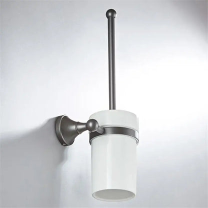 White ceramic toilet brush holder with matte black metal wall mount and handle in ornate brushed nickel gray bathroom accessories set