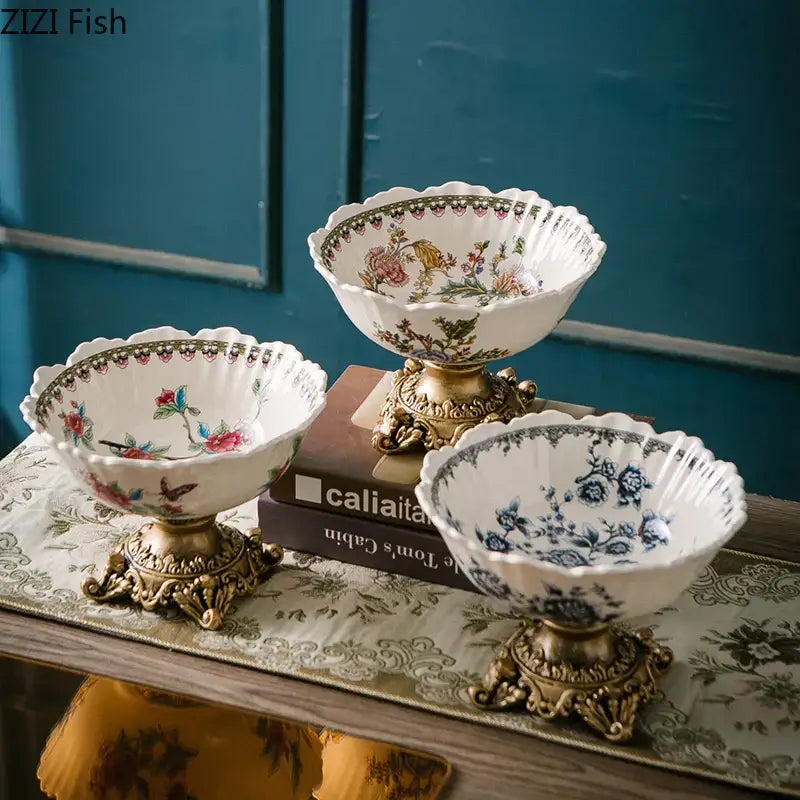 Three ornate ceramic flower pattern fruit bowls with colorful flower pattern and gold-toned decorative bases for dining room use