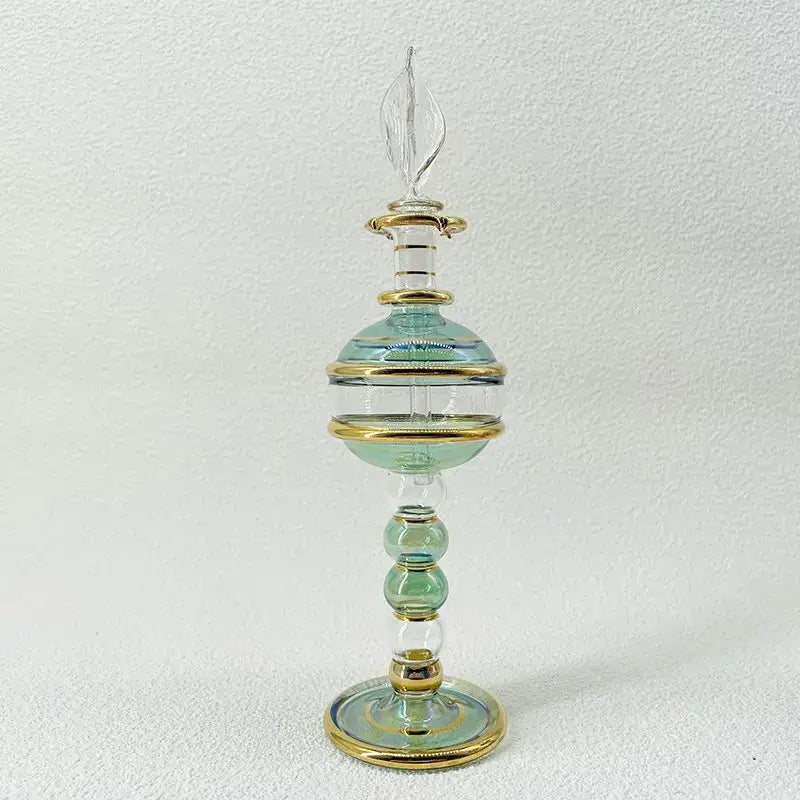 Delicate hand-blown glass bottle jewelry ornament with teal body and gold bands for bedroom decor