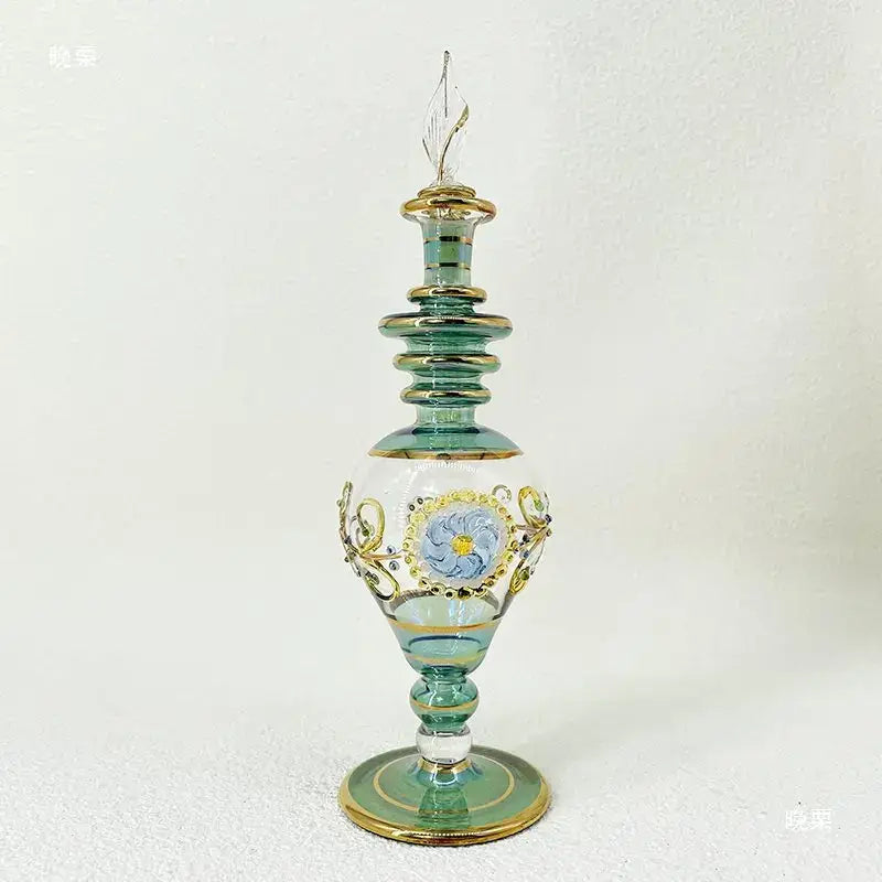 Ornate delicate teal glass bottle with gold trim and blue floral design for glass bottle jewelry and bottle jewelry ornaments
