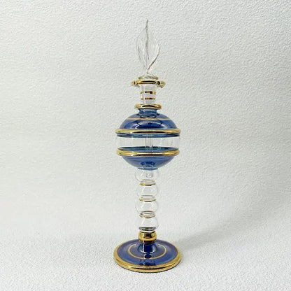 Elegant blue and gold glass bottle with clear flame-shaped stopper as ornate glass bottle jewelry ornaments for decor