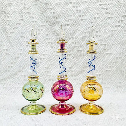 Three ornate colorful glass bottle jewelry ornaments with gold accents and hand-etched designs for bedroom decor