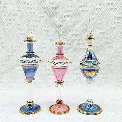 Three ornate colorful glass bottle jewelry ornaments with gold accents for elegant bedroom decor