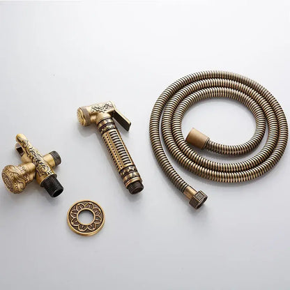 Ornate engraved gold brass wall mounted bidet faucet with antique brass finish and detailed decorbites brass wall sprayer