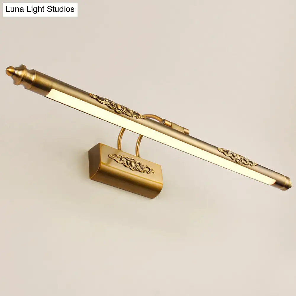 Ornate gold-toned brass wall vanity light with scrollwork detailing and warm white glow for bedroom sconce lighting