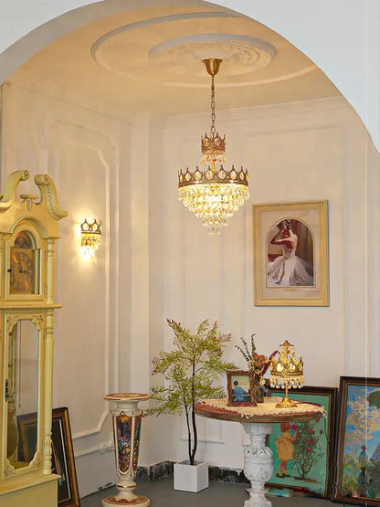 A gold ornate crown crystal led pendant light with crystal droplets for living room decorbites pendant light