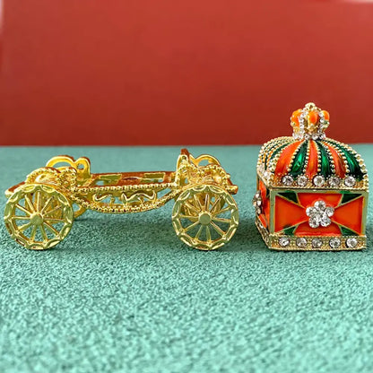 Ornate gold carriage jewelry box with orange and green enamel crown accents for elegant enamel crown jewelry storage