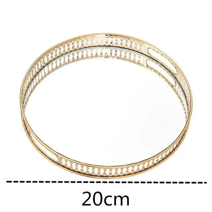 Ornate gold mirror glass storage tray with an openwork metal frame and mirrored center for jewelry decor