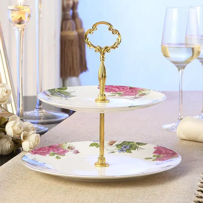Elegant two-tiered fruit plates set with gold-toned ornate handle and pink rose floral patterns on white ceramic plates