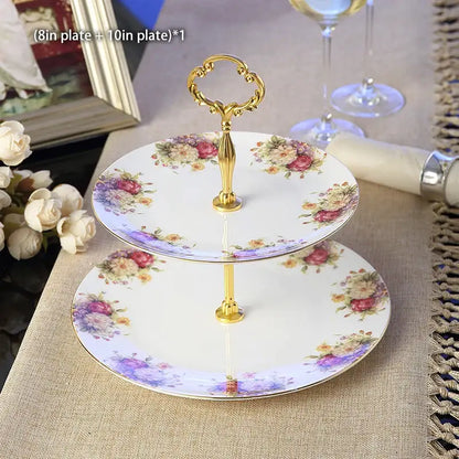 Two-tiered porcelain fruit plates set with gold ornate handle and floral patterns on white dining room stand