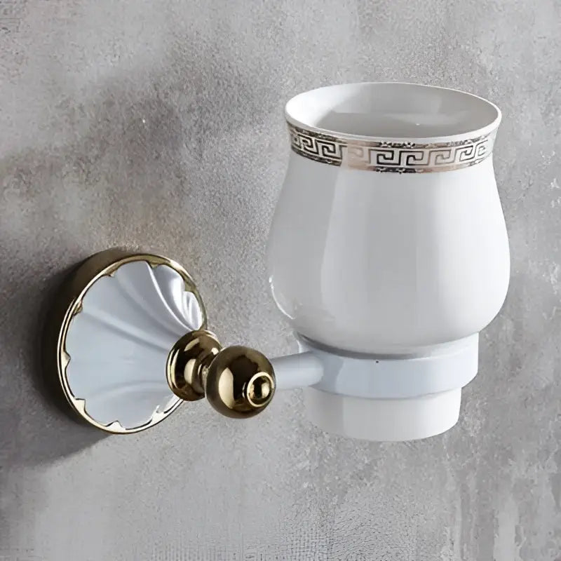 White ceramic toothbrush holder with gold greek key trim and wall bracket from decorbites bathroom accessories set