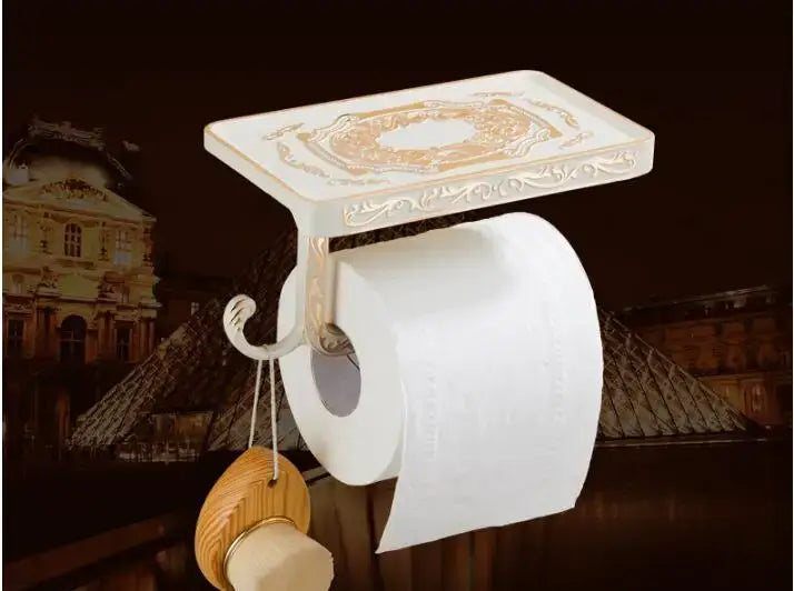 White and gold ornate toilet paper holder with decorative top part of decorbites bathroom accessories set
