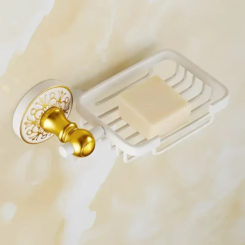 White wire soap dish with gold ornate wall mount holding pale yellow soap from decorbites bathroom accessories set