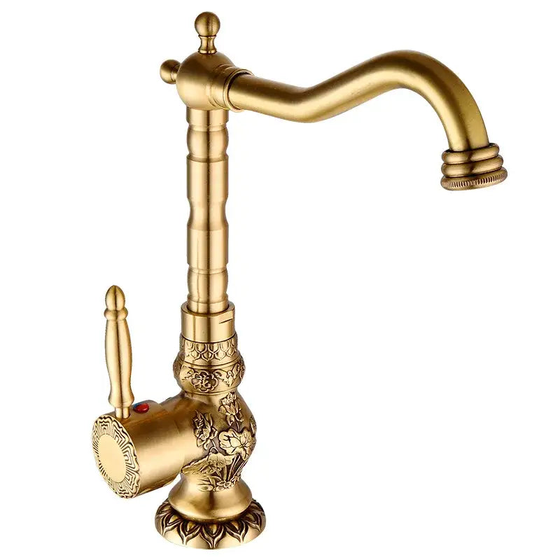 Ornate golden brass carved bathroom faucet with brass carved decorbites finish and classic curved spout design