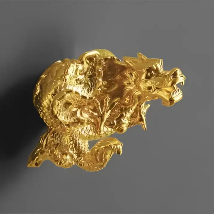 Ornate golden dragon bathroom hardware set featuring a detailed dragon-shaped brooch with textured scales and ceramic accents