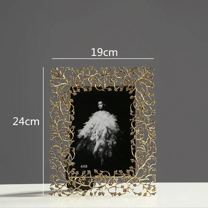 Ornate gold-toned metal photo frame with intricate vine and leaf detailing decorbites golden leaves metal decor