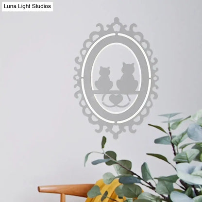 Ornate gray cat silhouette led wall light featuring a delicate silver-toned oval frame inch fixture for kitchen decor
