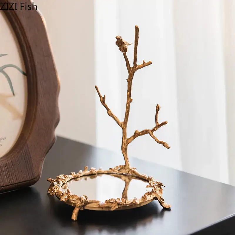 Ornate leaf handle decorbites golden mirror glass tray with golden branch jewelry stand and intricate leaf detailing