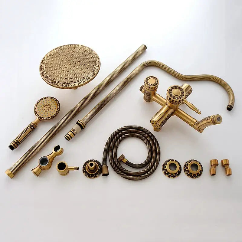 Antique brass shower faucet set with ornate textured detailing on rainhead and handheld for bathroom use