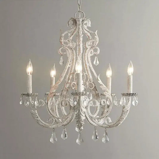 Ornate white decorbites iron crystal chandelier with intricate wrought iron detailing and crystal droplets for living room