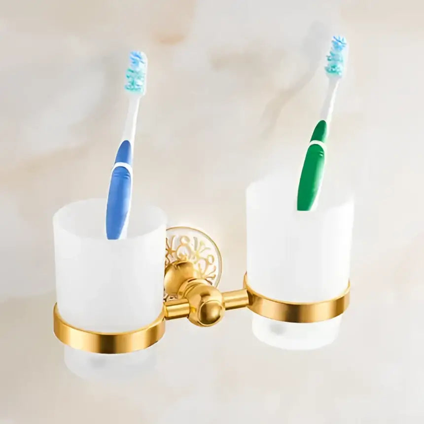Gold-toned double toothbrush holder with frosted white cups in ornate white and gold decorbites bath hardware set