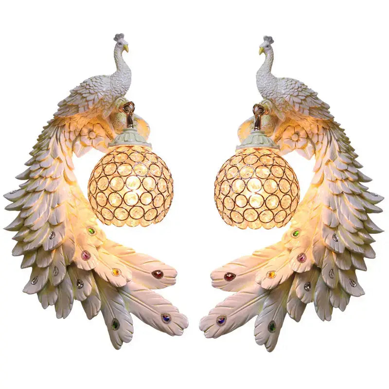 Ornate white gold peacock crystal wall lamp pair featuring iridescent feathers and spherical glass shades decorbites gold peacock