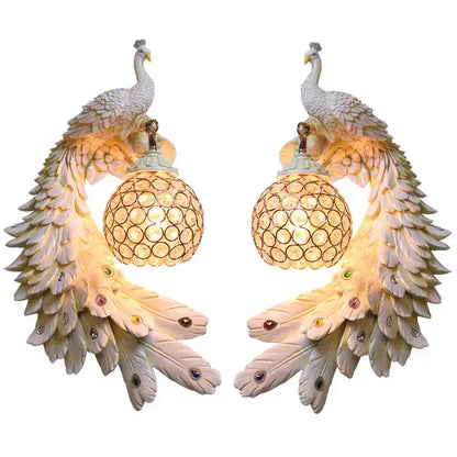 Ornate white gold peacock crystal wall lamp pair featuring iridescent feathers and spherical glass shades decorbites gold peacock