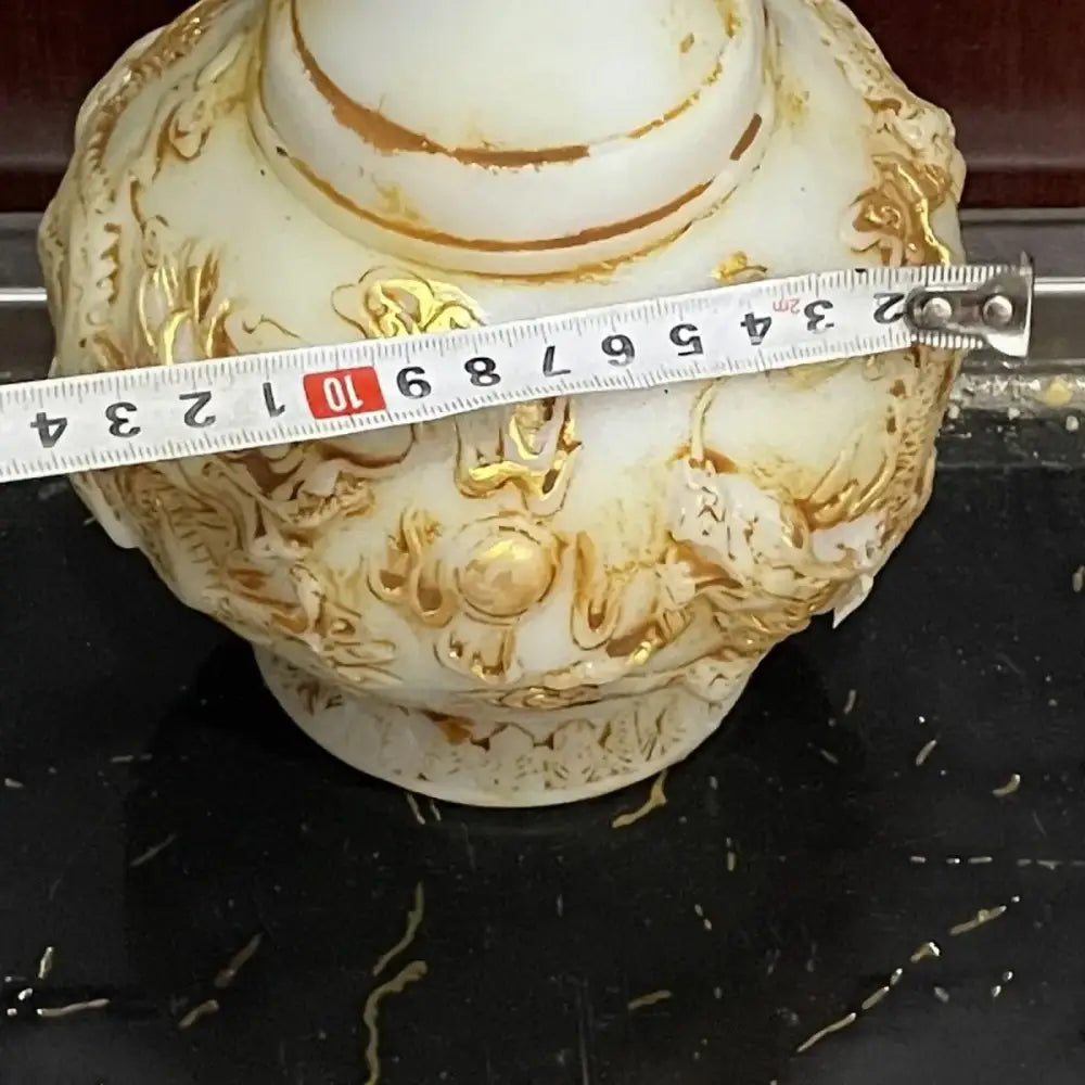 Ornate white porcelain vase with gold leaf detailing and embossed floral patterns for white marble jade dragons decorbites decor