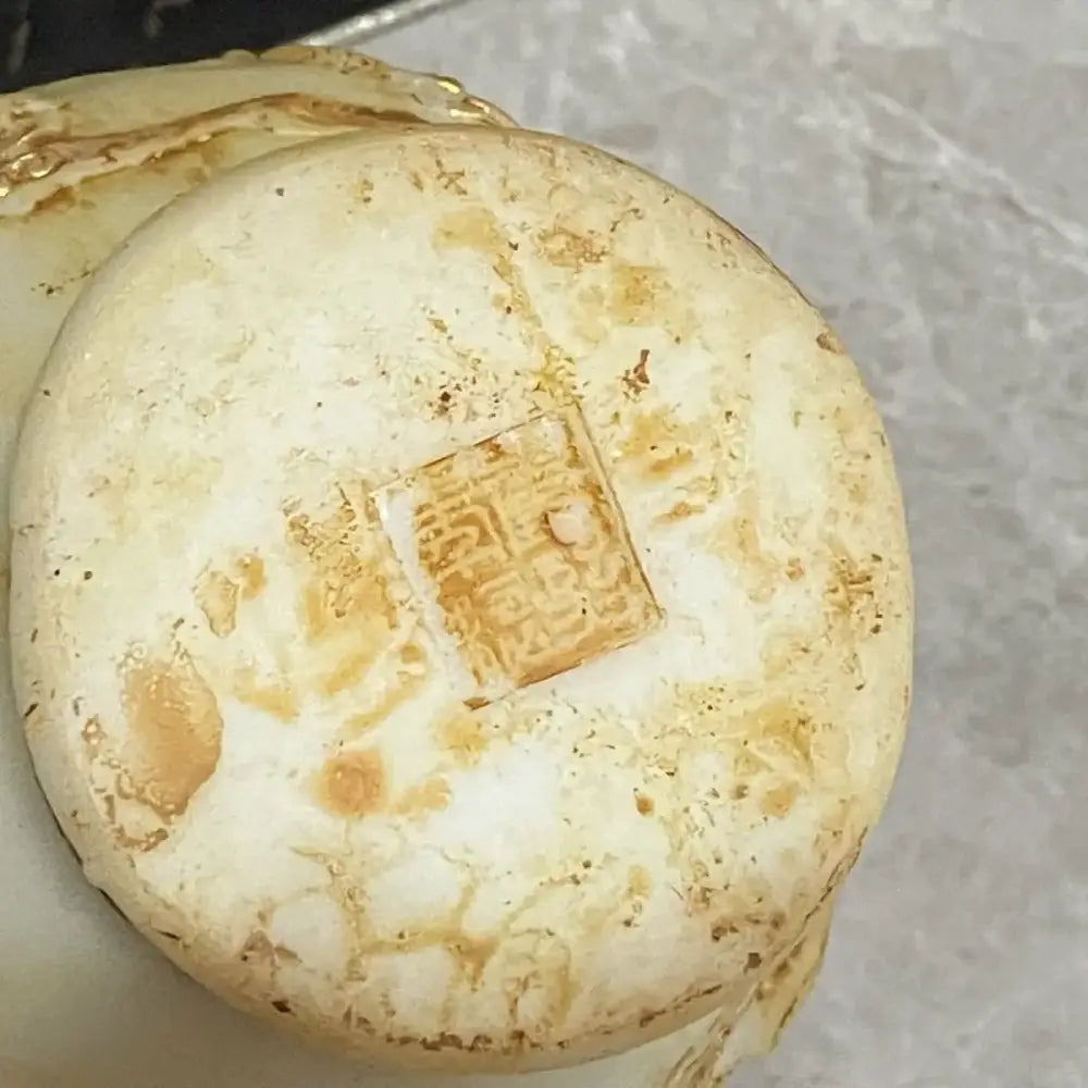 A weathered off-white ceramic coin with a square seal and brown patina for decorbites white marble jade dragons decor
