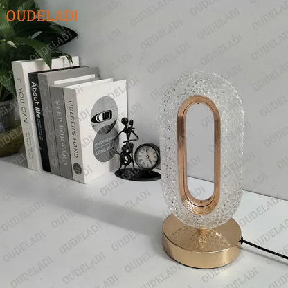 A modern oval-shaped crystal bedroom table lamp with textured clear glass and rose gold frame for decorbites crystal bedroom