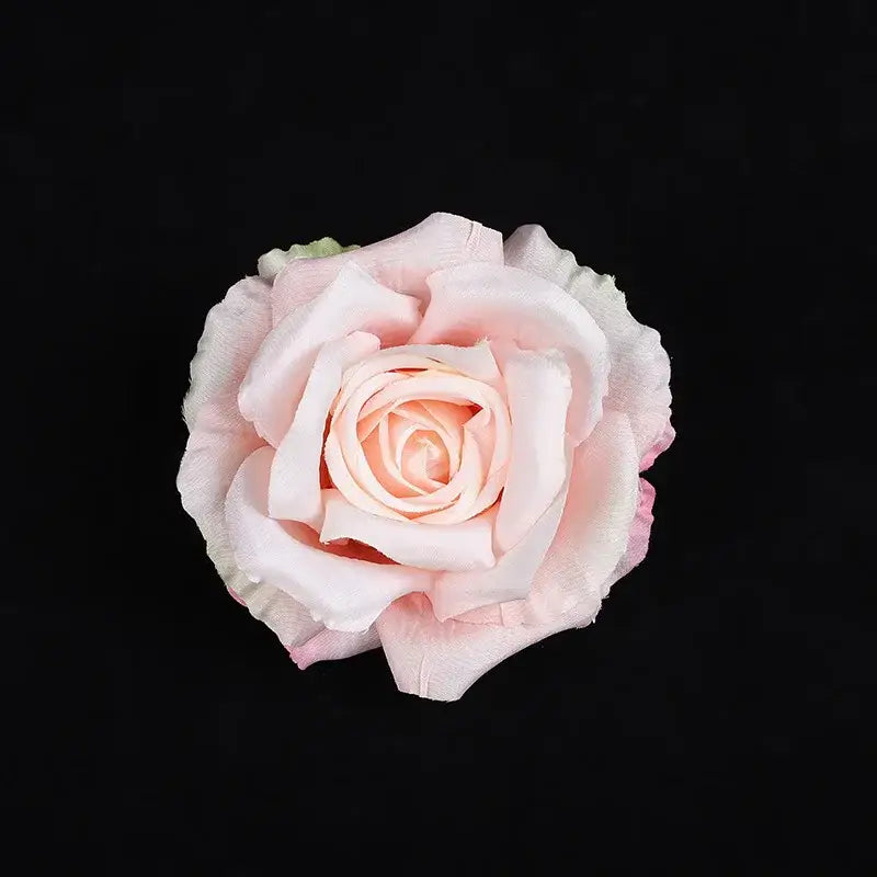 A delicate blush pink artificial rose with softly layered petals from the pastel 30pcs silk roses wedding decor