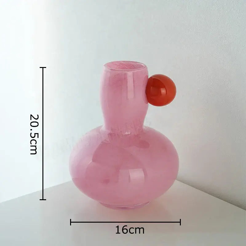 Pastel blue and lavender colorful ball glass vase with a translucent pink bulbous base and glossy orange handle decorbites decor