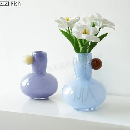 Pastel blue and lavender colorful ball glass vases with rounded bodies and cream brown spherical handles for decorbites decor