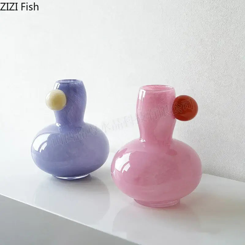 Two pastel-colored ball glass vases in blue and lavender with colorful ball decorbites accents for living room decor