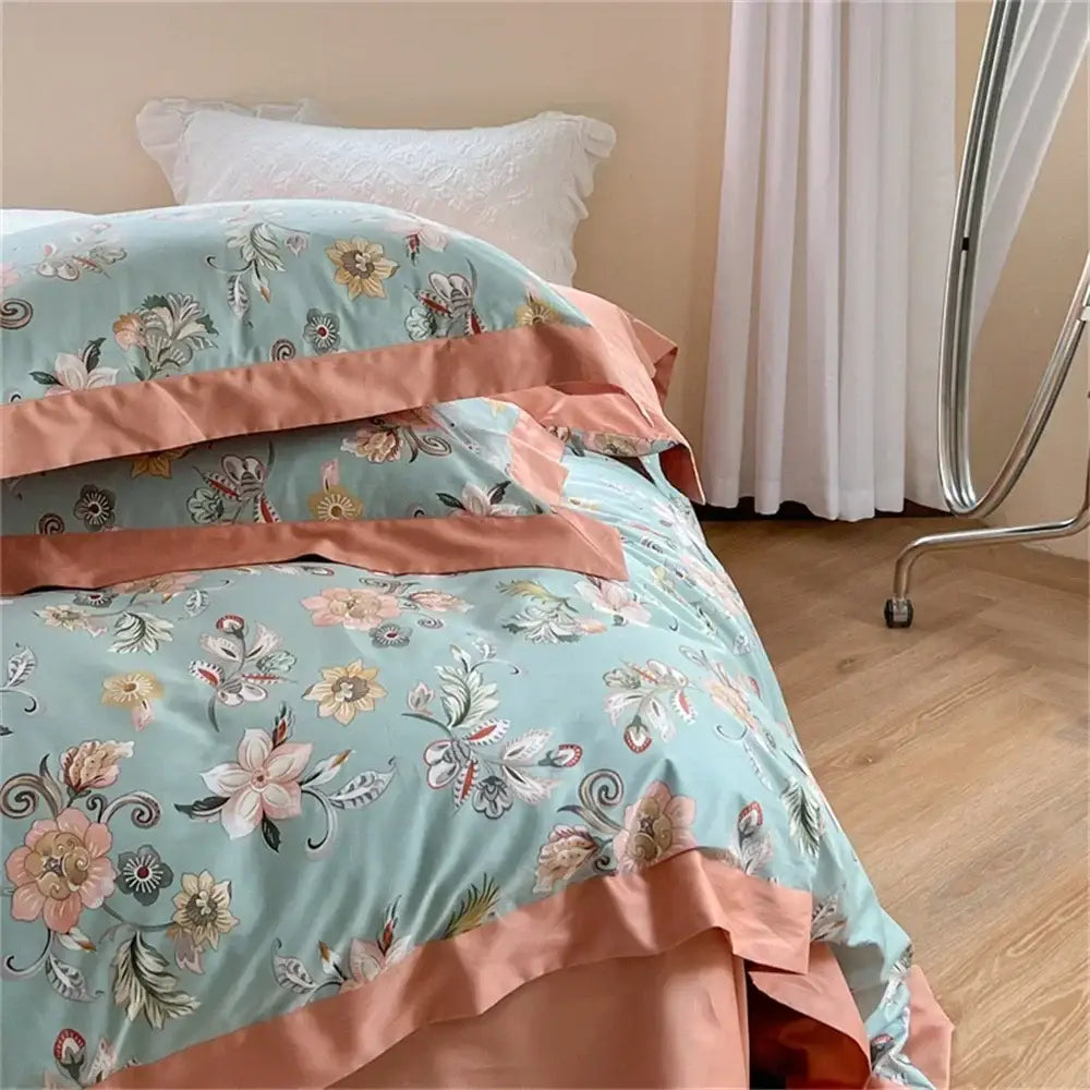 Pastel blue and peach floral bedding set with soft mint green duvet cover featuring delicate embroidery and satin trim