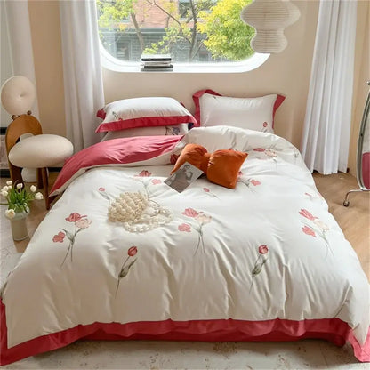 White duvet cover with pink floral embroidery and ruffled hem from pastel blue and peach colorful bedding set decorbites