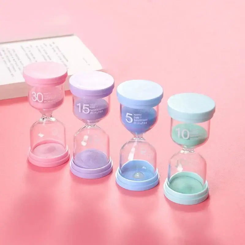 Pastel blue and pink hourglass sand timer set with clear glass bodies and plastic tops marked for 5 to 30 minutes