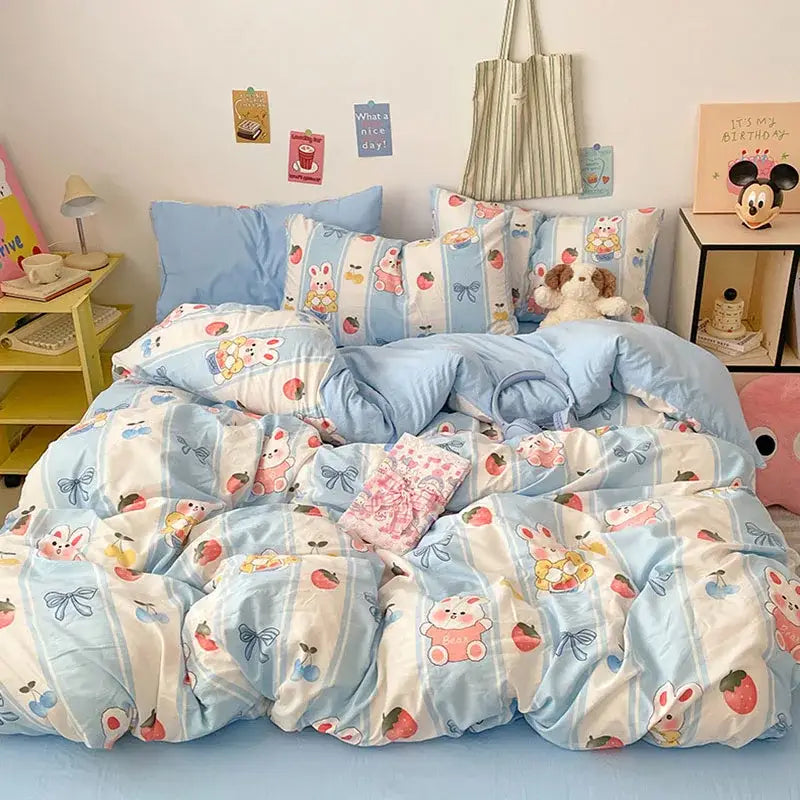 Pastel blue and white cotton bed sets with a decorbites cartoon pattern featuring bunnies and strawberries in plush fabric