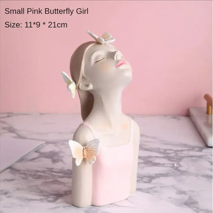 A delicate pastel butterfly girl flower resin ornament with closed eyes pink lips and white butterflies for living room use