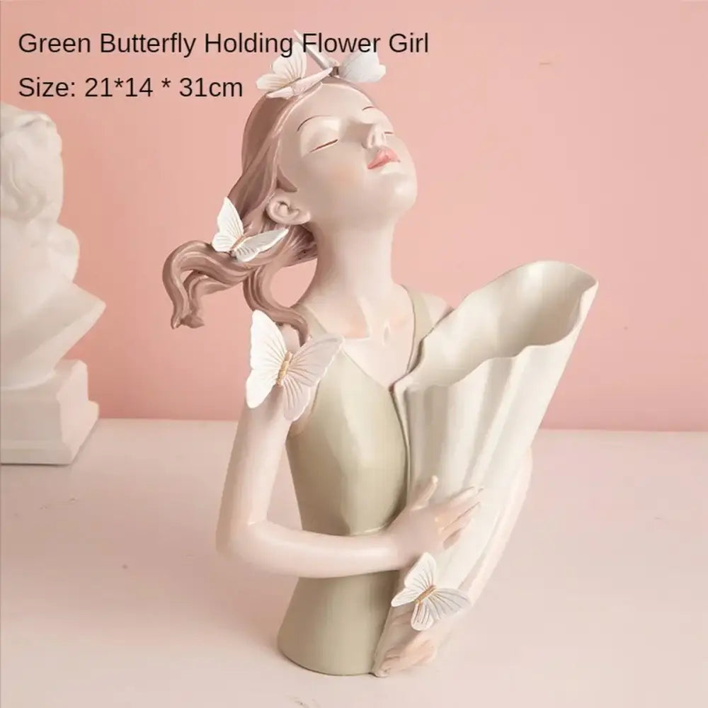 A delicate pastel butterfly girl resin flower vase ornament with white butterflies holding a large white flower