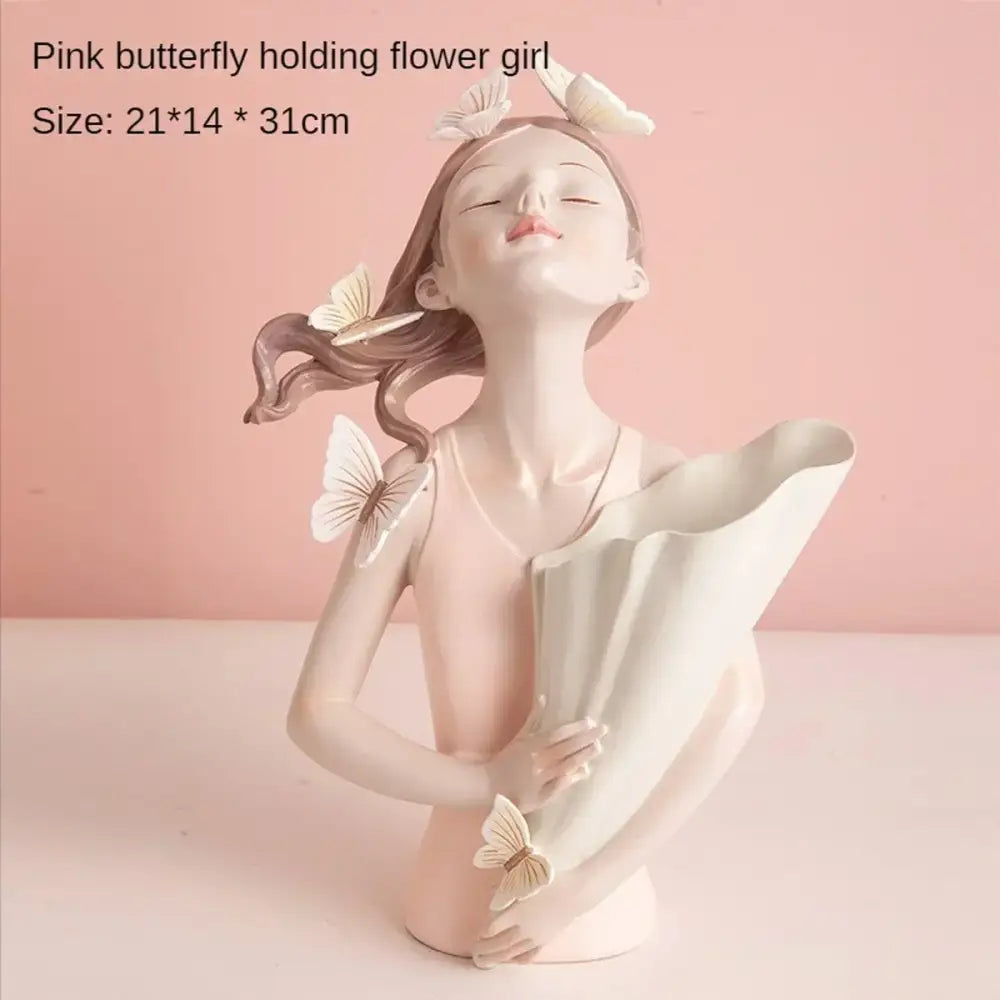 Delicate pink resin butterfly girl figurine holding white flower bouquet with butterflies used as flower vase decor